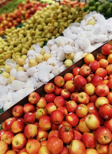 A vibrant display of fresh apples and pears at a local market stall, perfect for a healthy lifestyle.